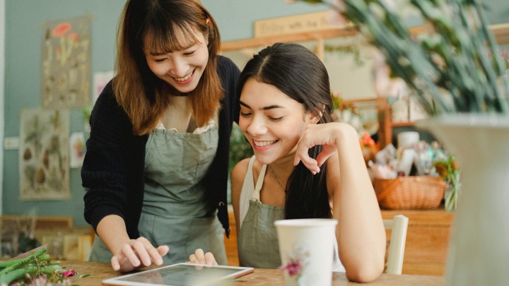 Two woman looking an IPad 