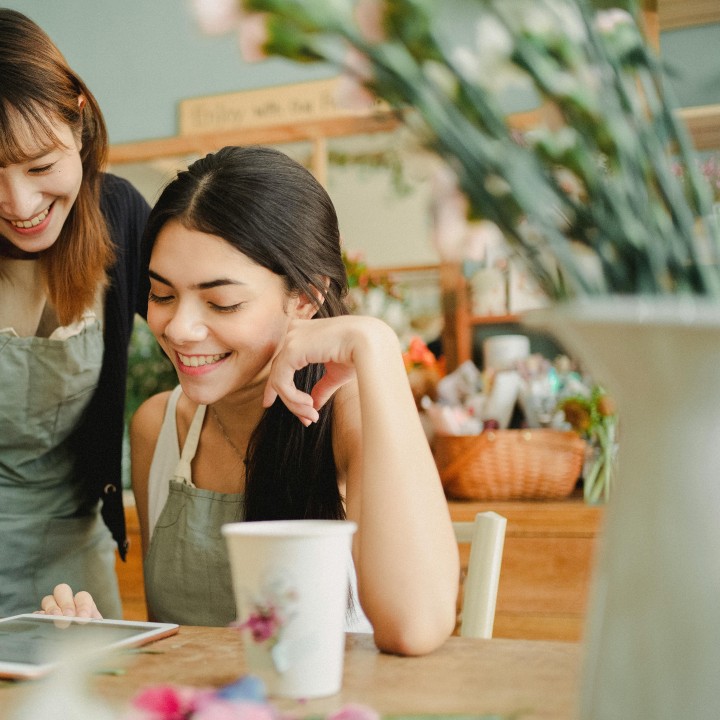 Two woman looking an IPad 