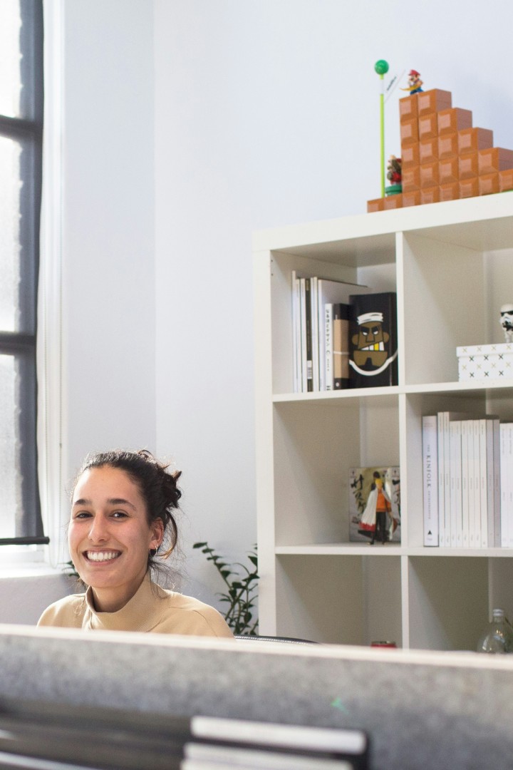 Woman behind a desk smiling