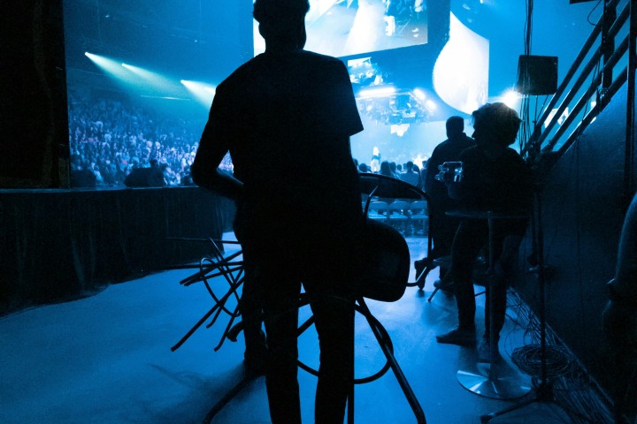 Beyond the STAGE crew carrying a chair